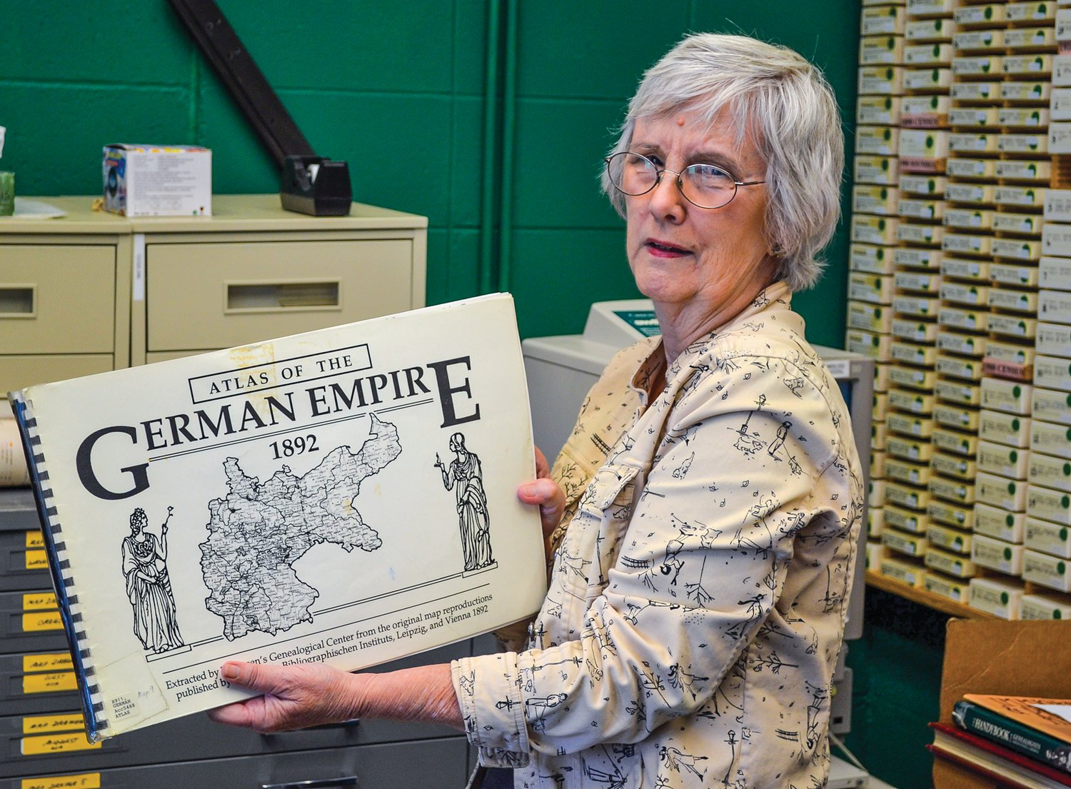 Marcia Grubb, Clark County Genealogical Society vice president, displays one of the many documents found in the society’s library that opened to the public on July 13.
